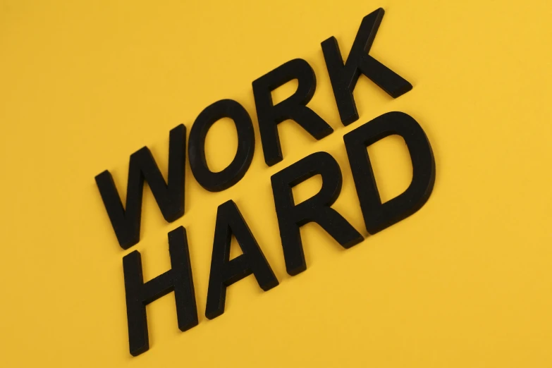 the words work hard are outlined in 3d letters