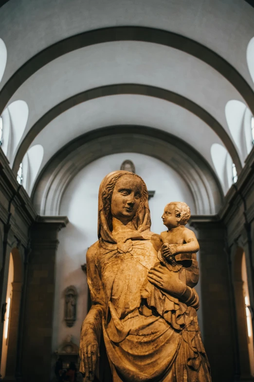 a statue of a woman holding a baby in a church