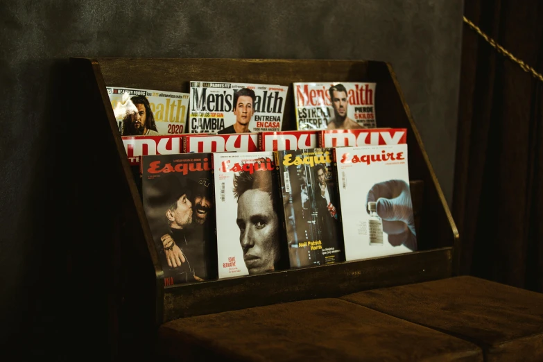 the man's magazine rack is holding all his magazines