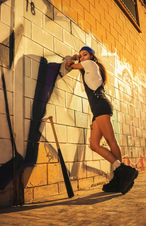 a girl poses in front of the graffiti on the wall