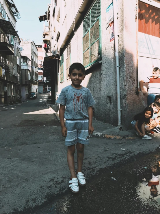 small child standing in an urban area on the street