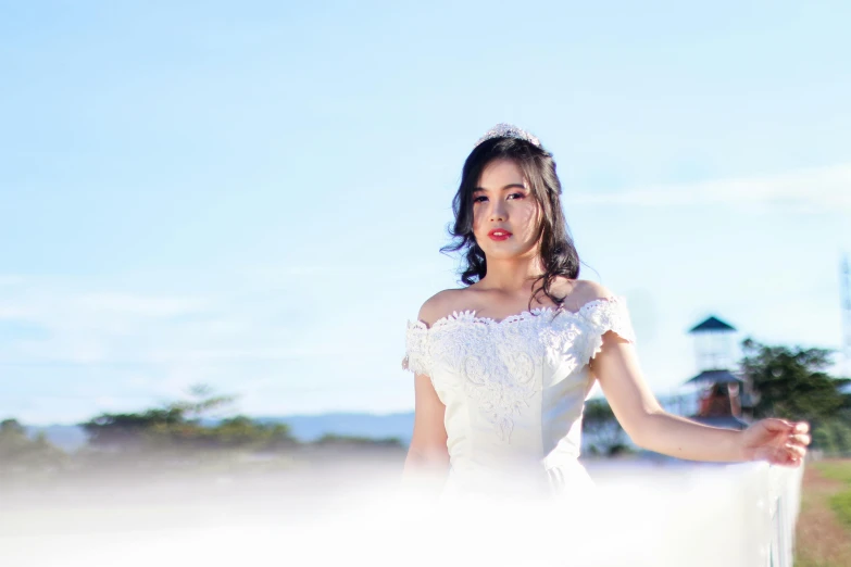 a woman in a wedding dress in the sand