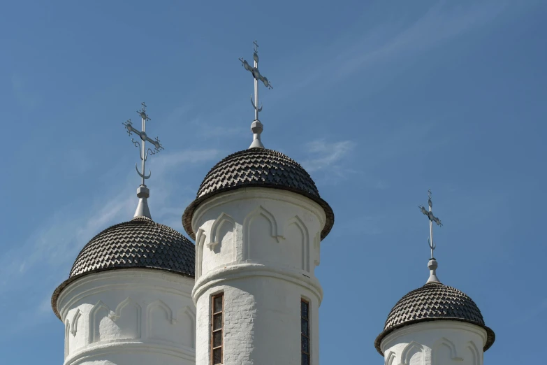 two tall white structures with crosses and crosses on top