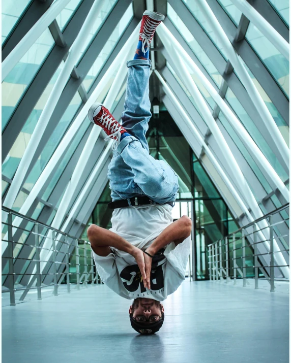 man performing a hand stand with his hands in the air