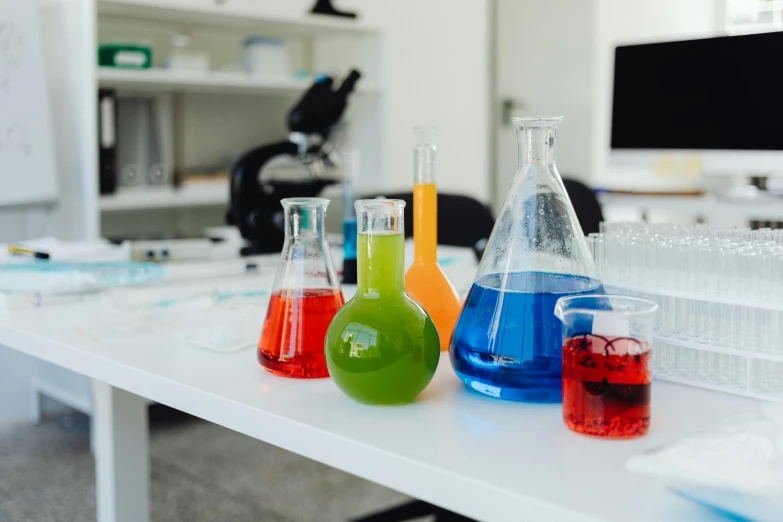 colorful flasks in glasses on a table