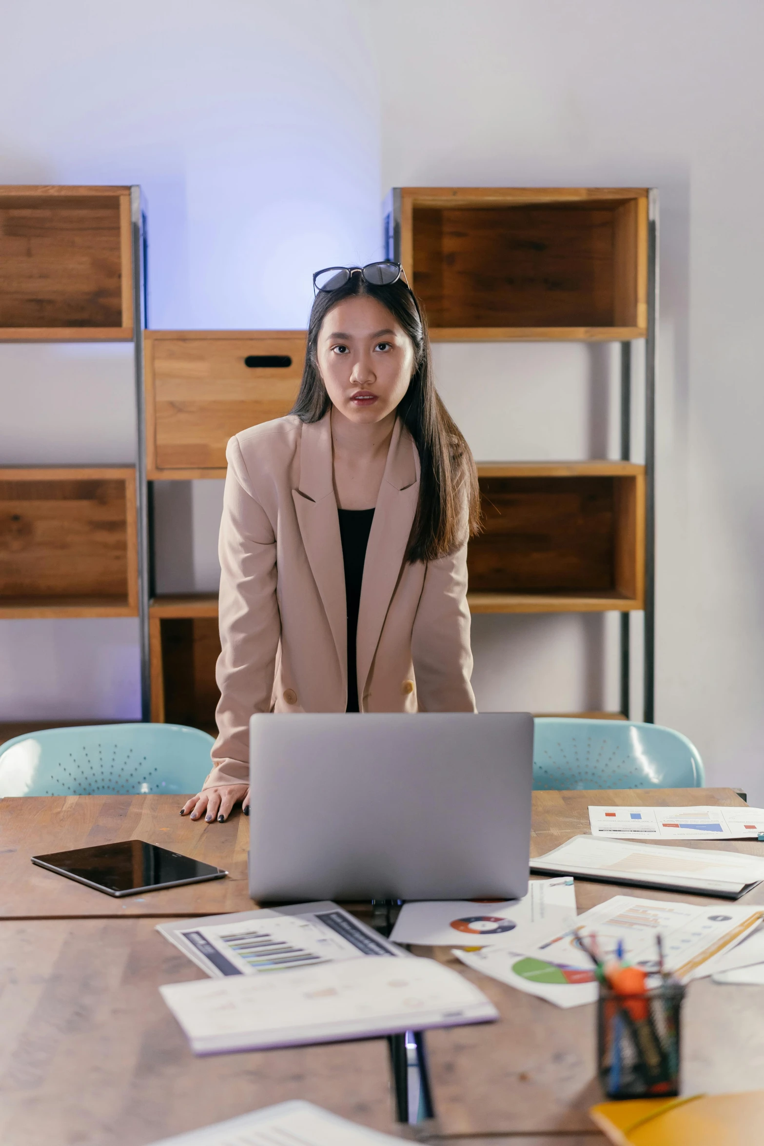 a woman in a business suit looking down at her computer screen