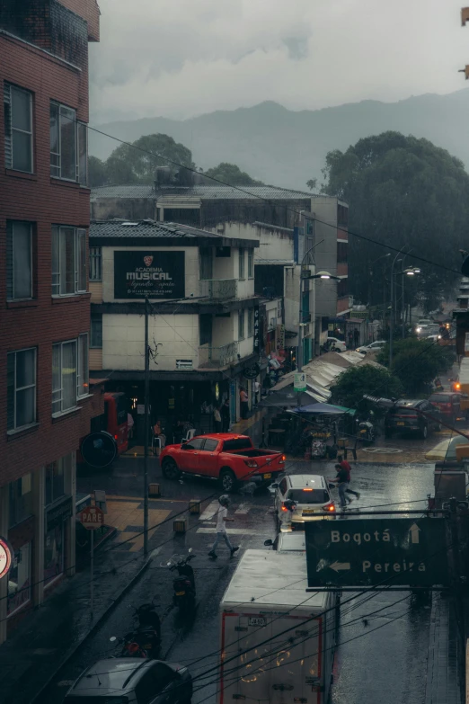 traffic moves through a rain soaked city streets