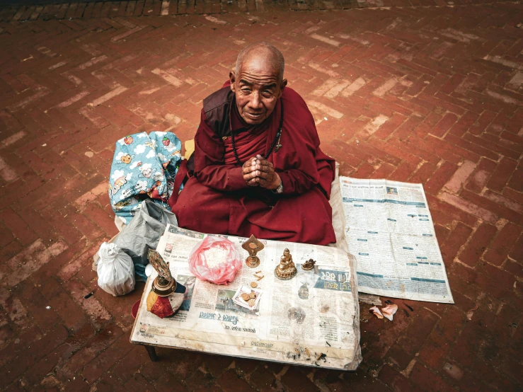 a man sits in front of his travel map while looking at the camera