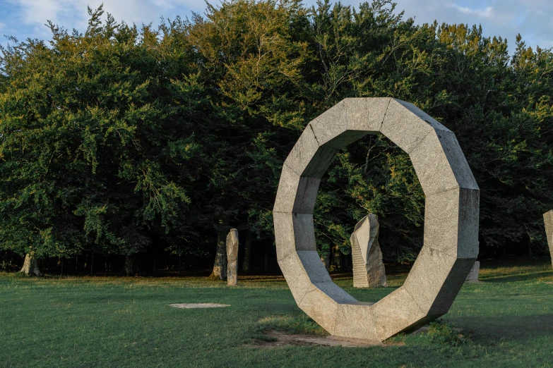 sculptures are arranged in a circle, on grass
