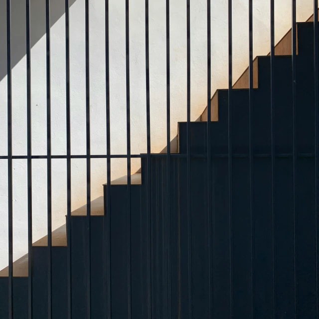 an image of a man climbing up steps with a skateboard