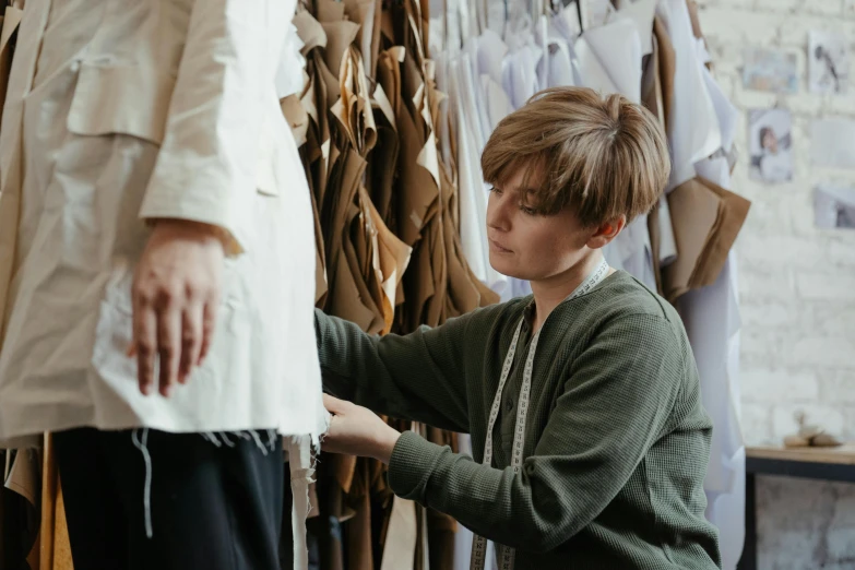 woman looking at clothes while hanging from clothes rack