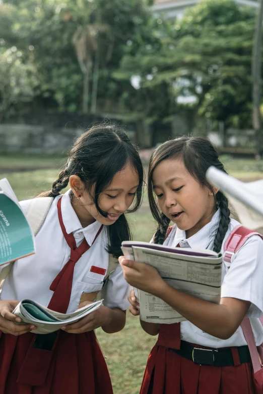 two s looking at a book