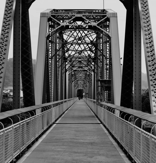 this is an old black and white pograph of a bridge