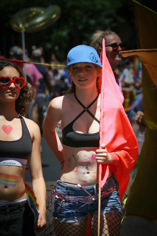 two people that are walking together with some flags