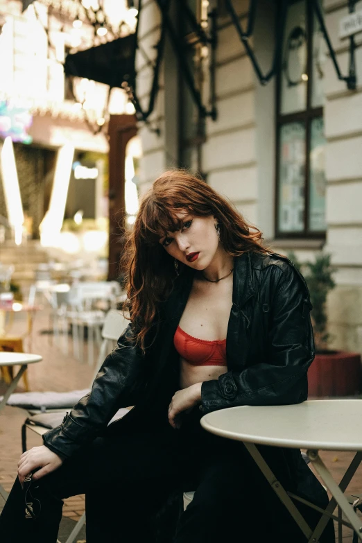 a woman sitting on top of a white table