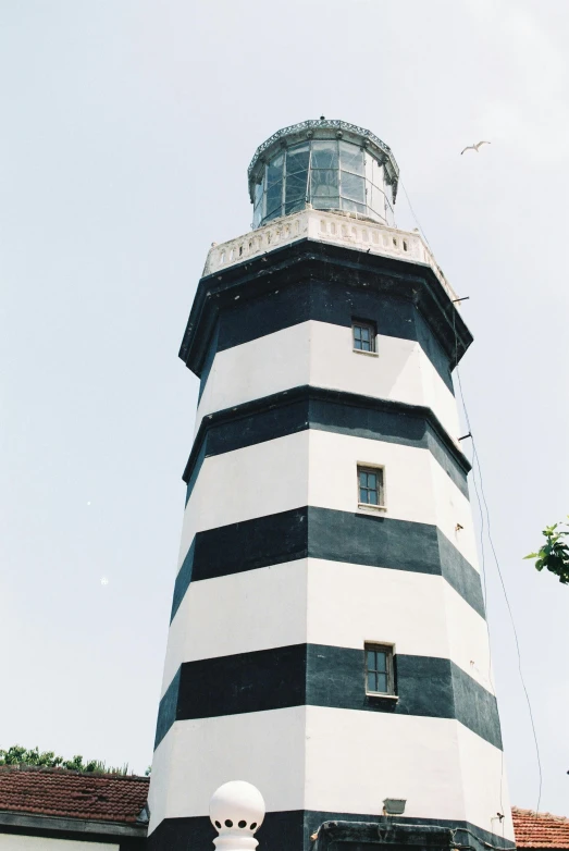 an old lighthouse with a top on the front of it