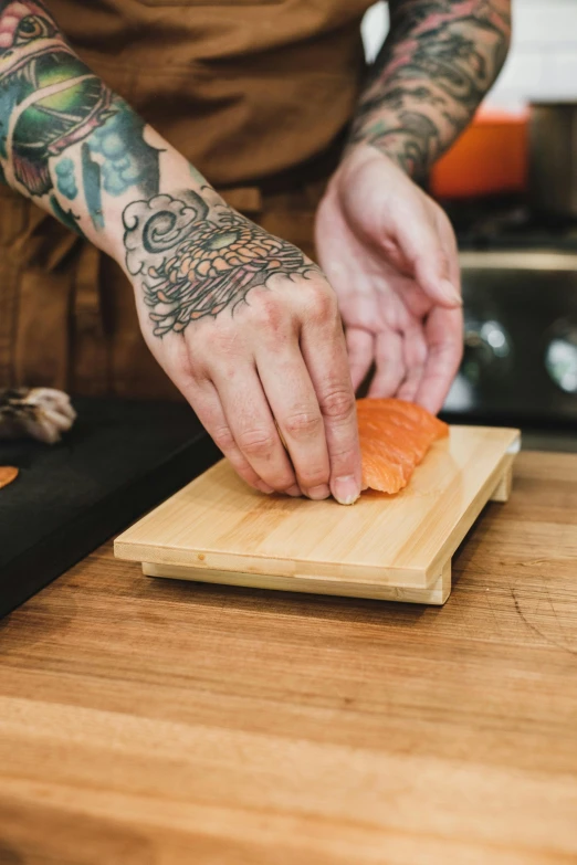 a person  a salmon on a board