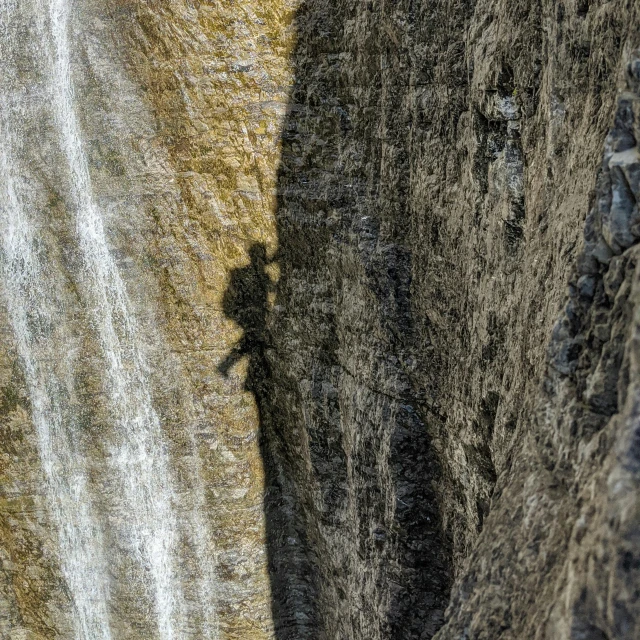 a person climbing up the side of a mountain