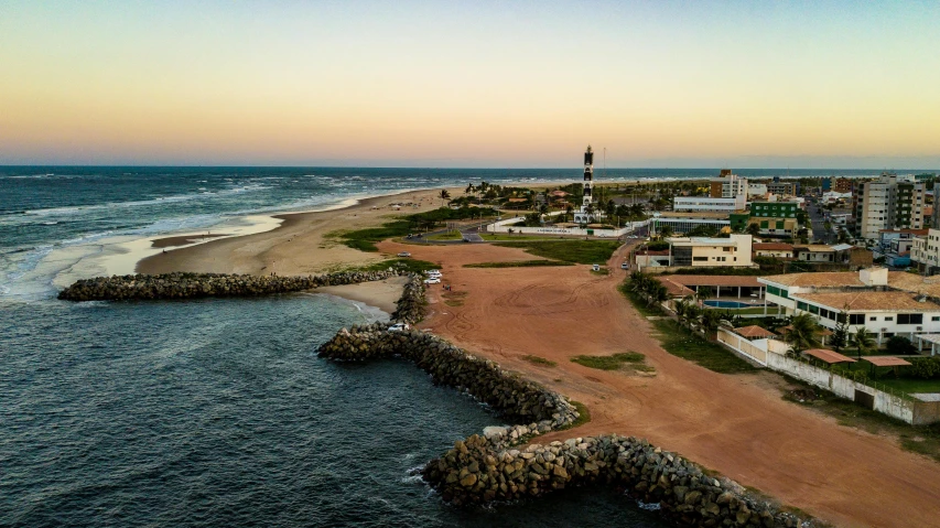 an aerial view of an ocean and a sandy beach