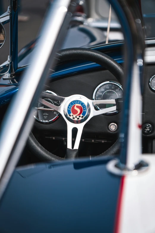 steering wheel on an older model blue car