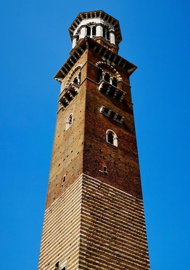 a tall brick tower that has a clock on top