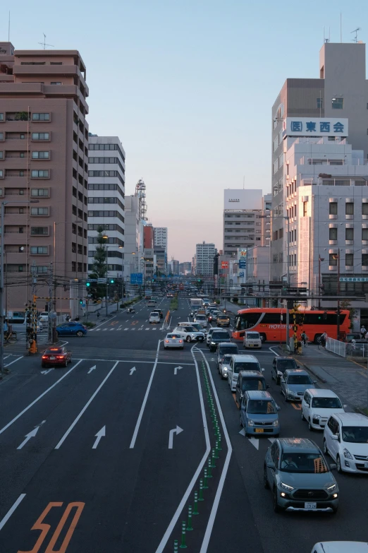 several vehicles are traveling in a busy city street