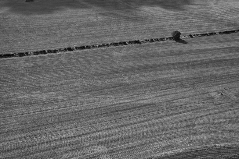 the long line of dirt is beside a hill