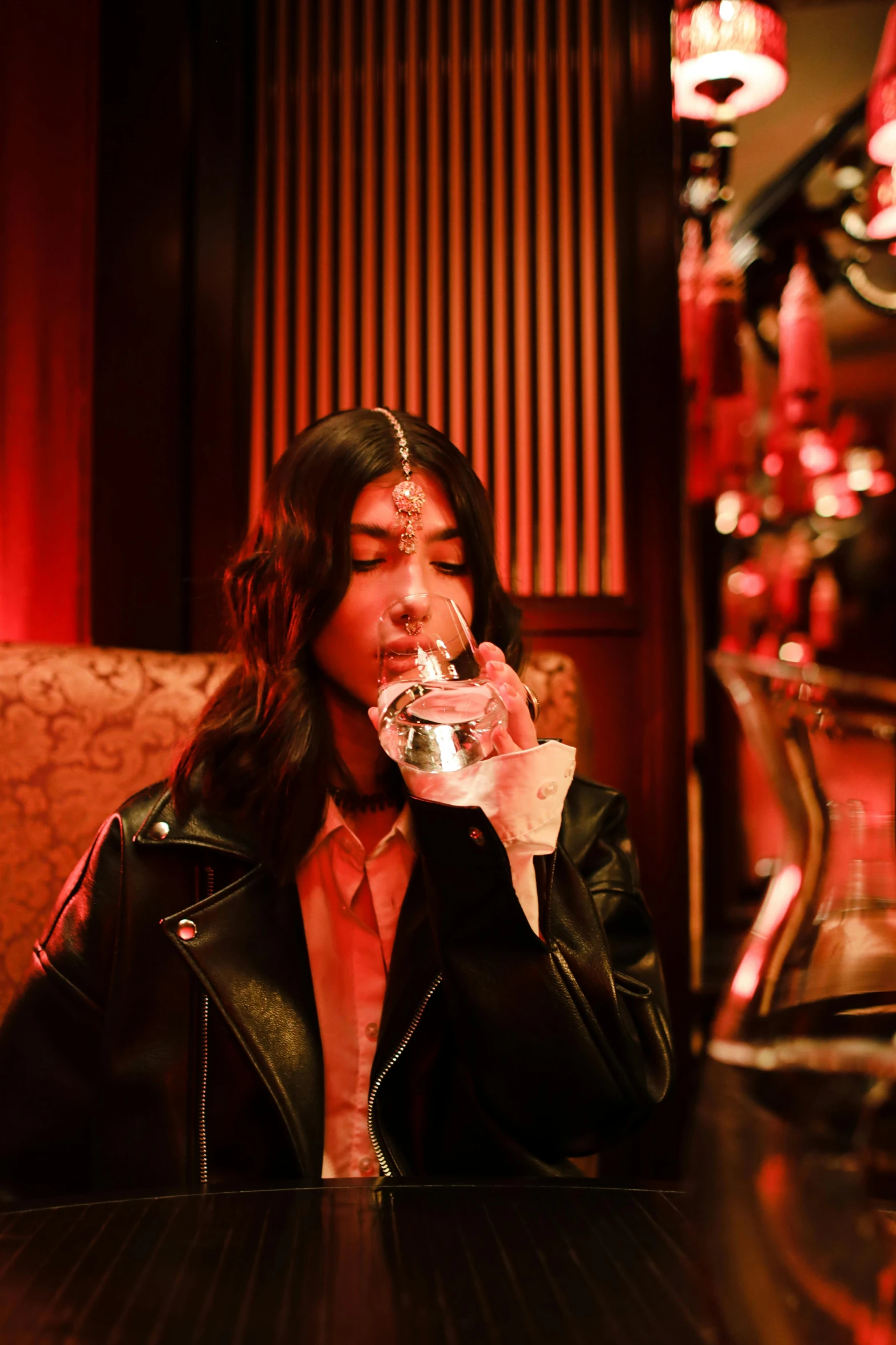 a woman with long hair is eating a sandwich