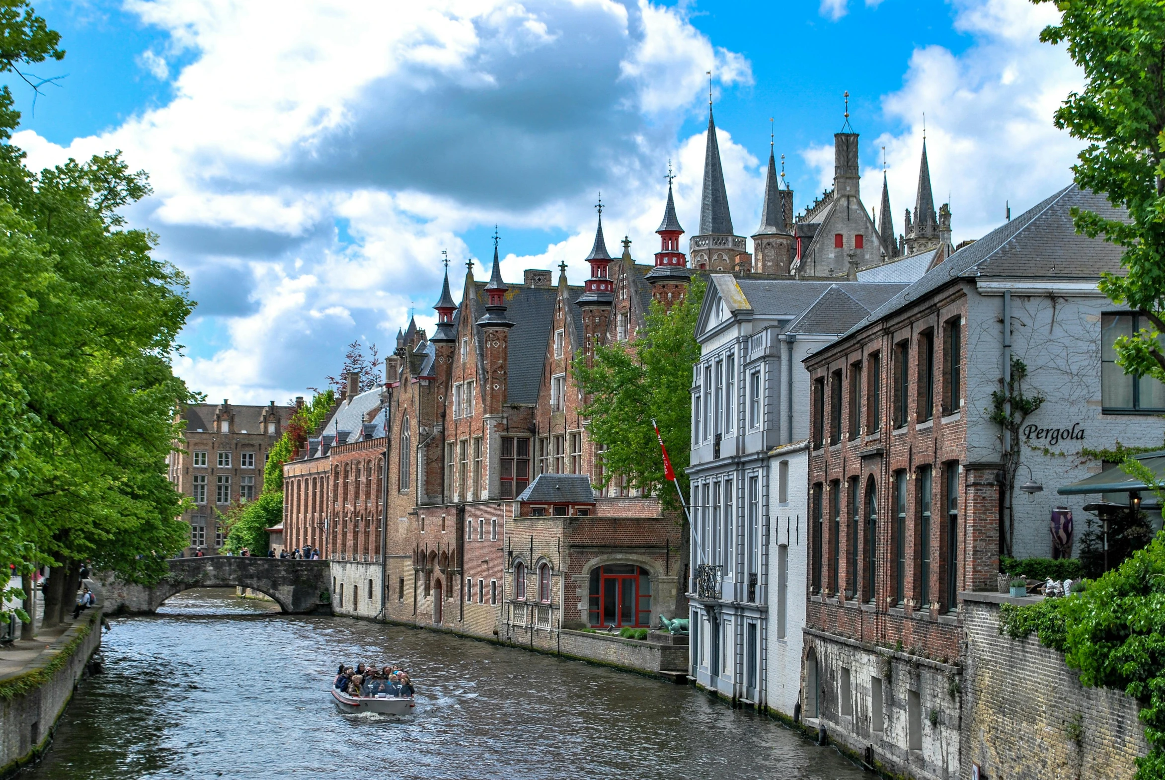 there is a boat in the river moving along a narrow waterway