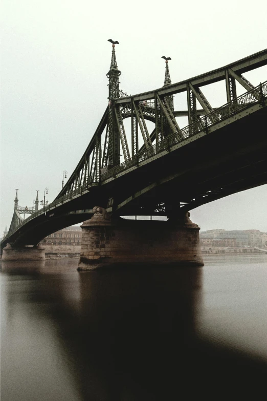 an old bridge spanning over a wide body of water