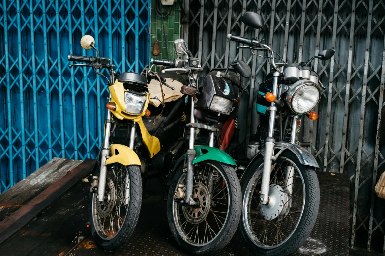 a pair of motor cycles next to a building