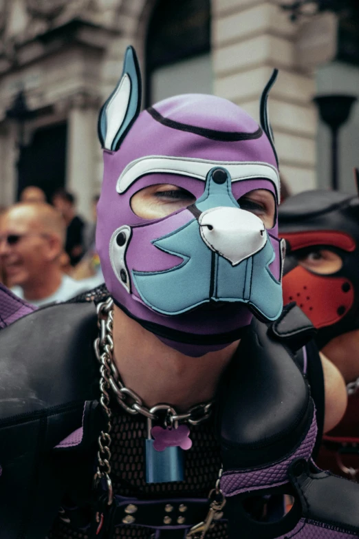 a guy with purple leather clothes and a face mask