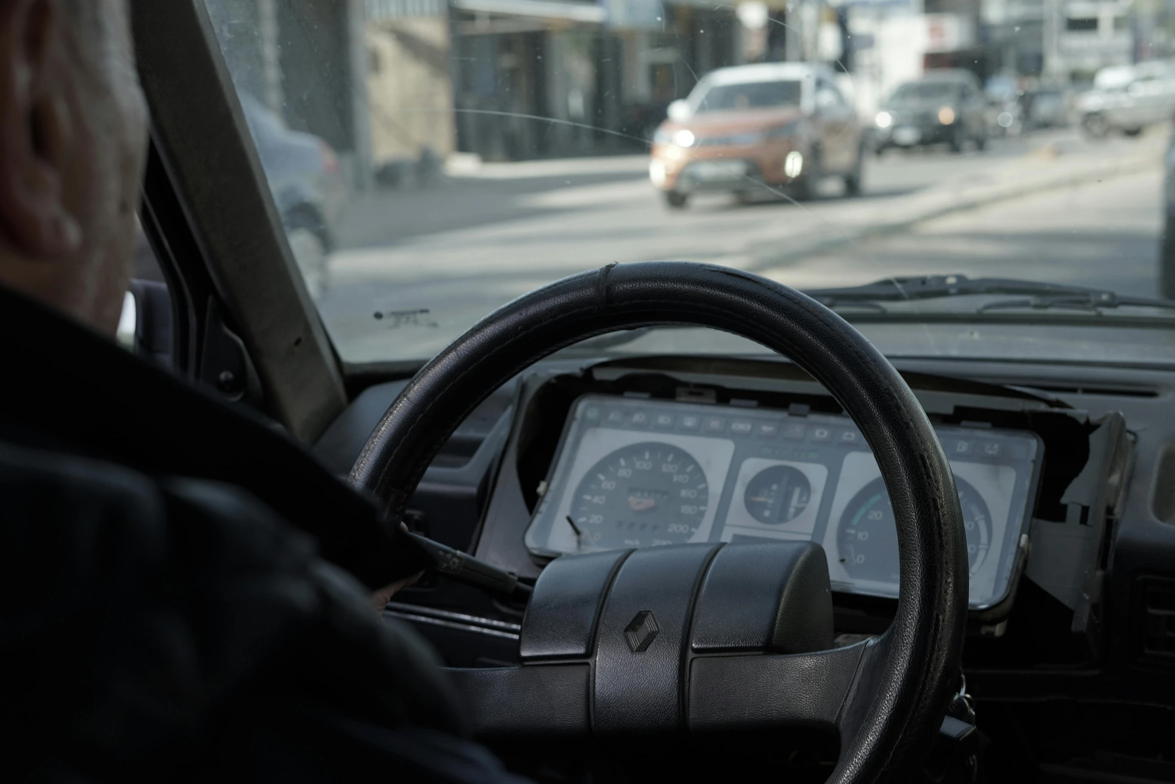 view through dashboard of an old car moving down the road