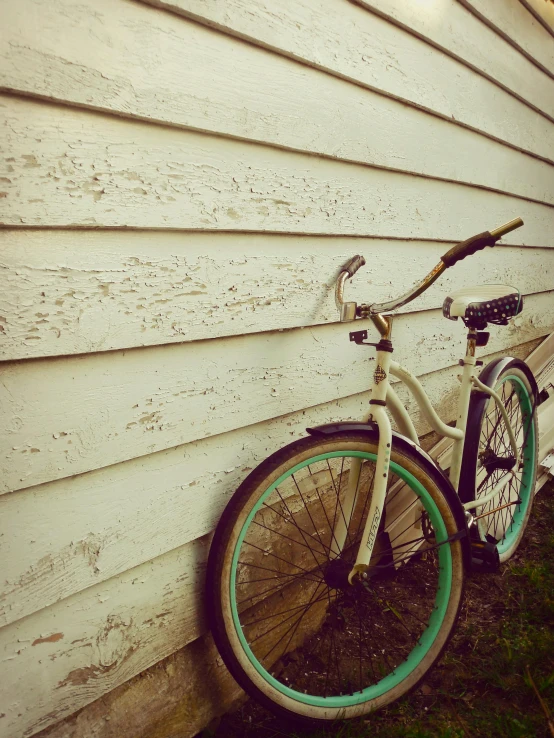 a bicycle is parked on the grass near a house