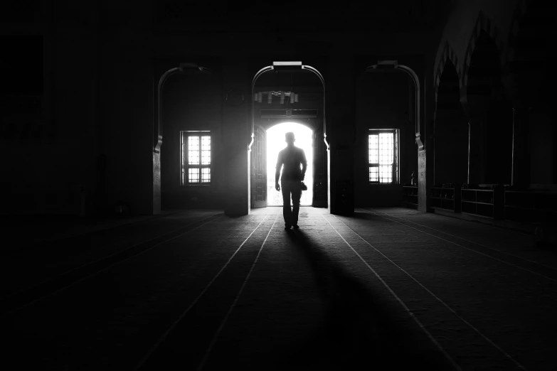 a person stands at the entrance to an empty building