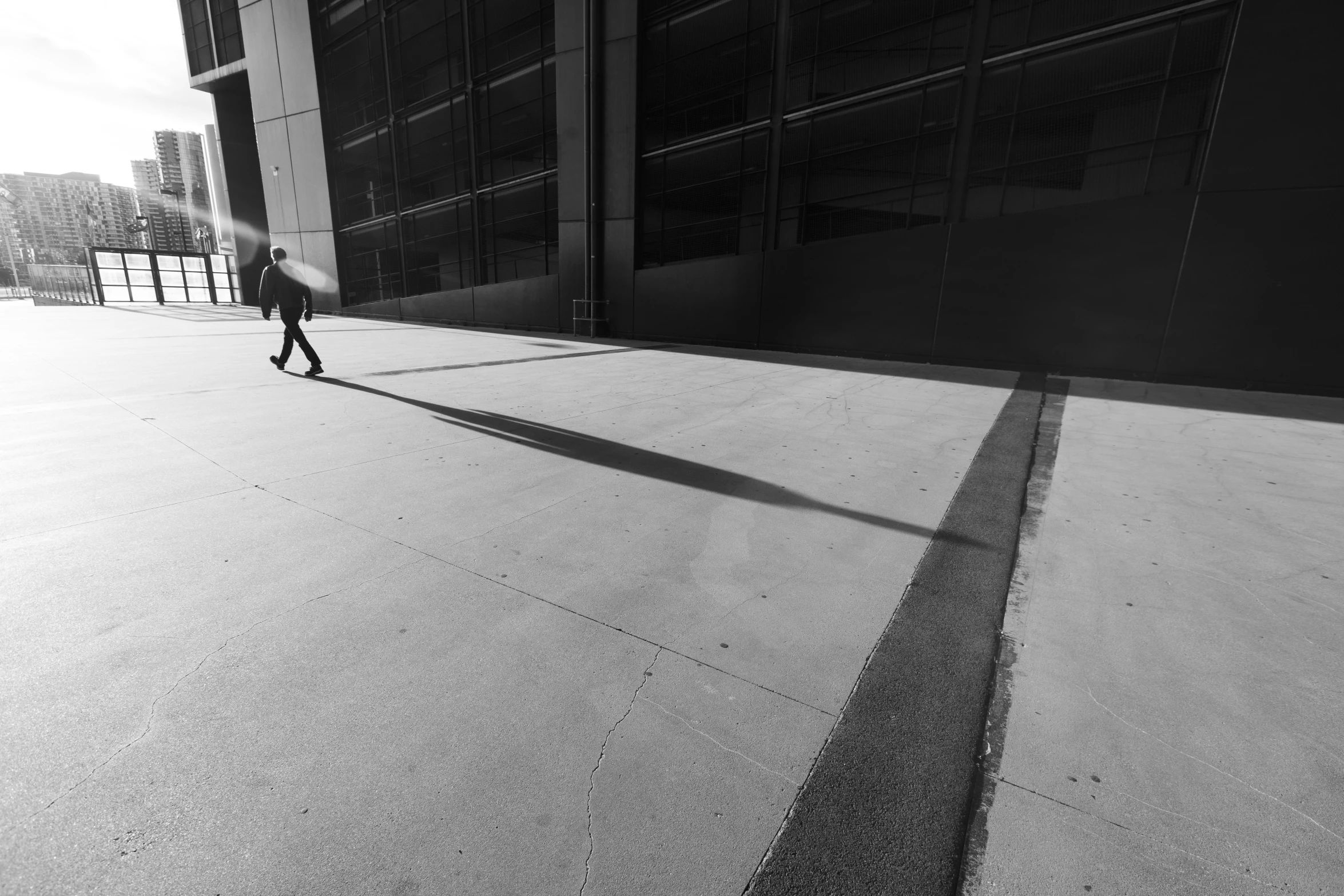 a man walking down the street as he holds onto his umbrella