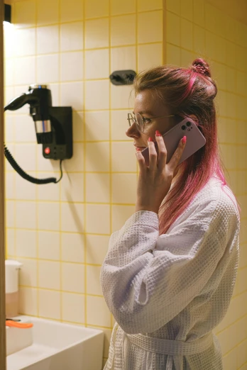 a woman with pink hair on a cell phone