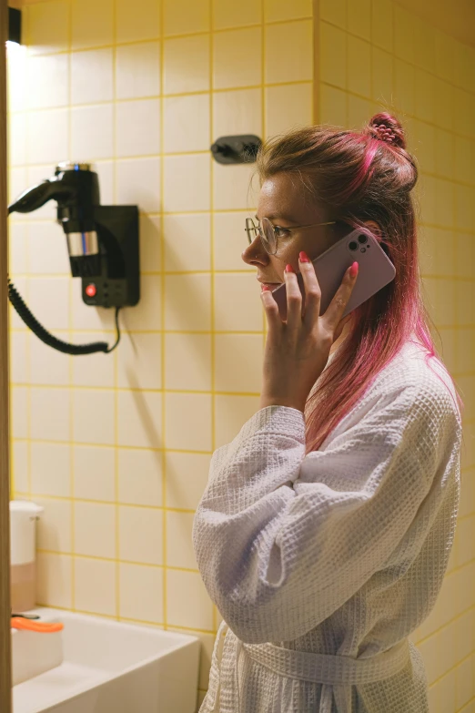 a woman with pink hair on a cell phone