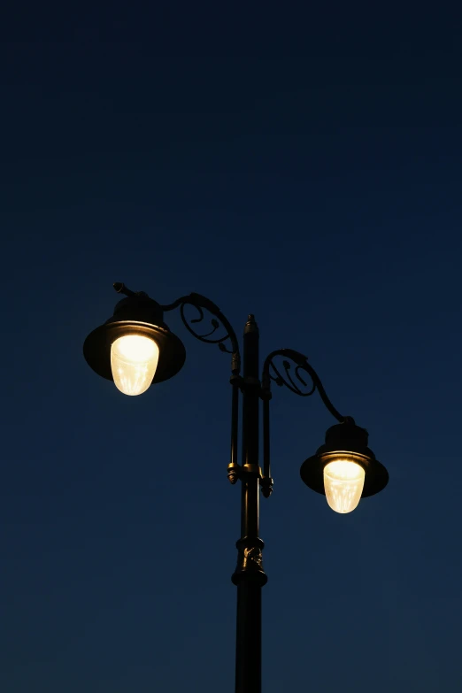 a street lamp at night under a dark sky