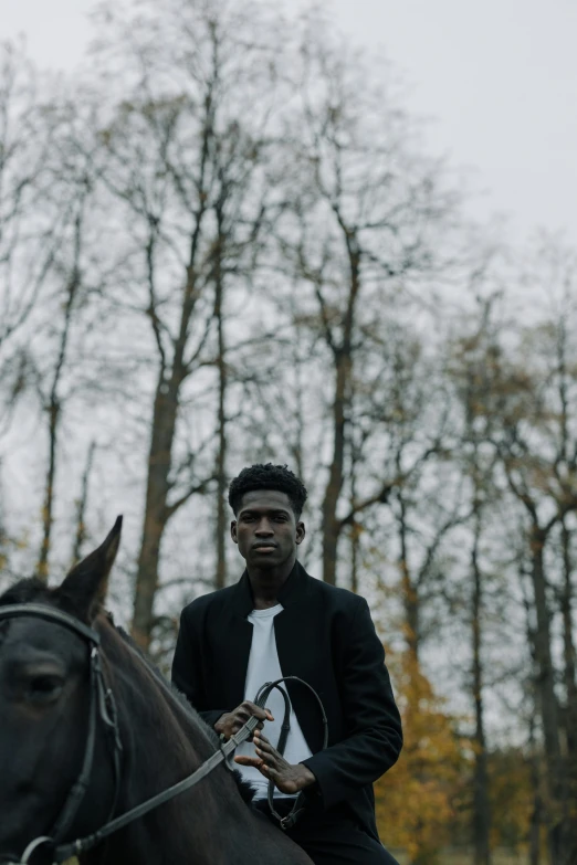 a black man is riding on top of a brown horse