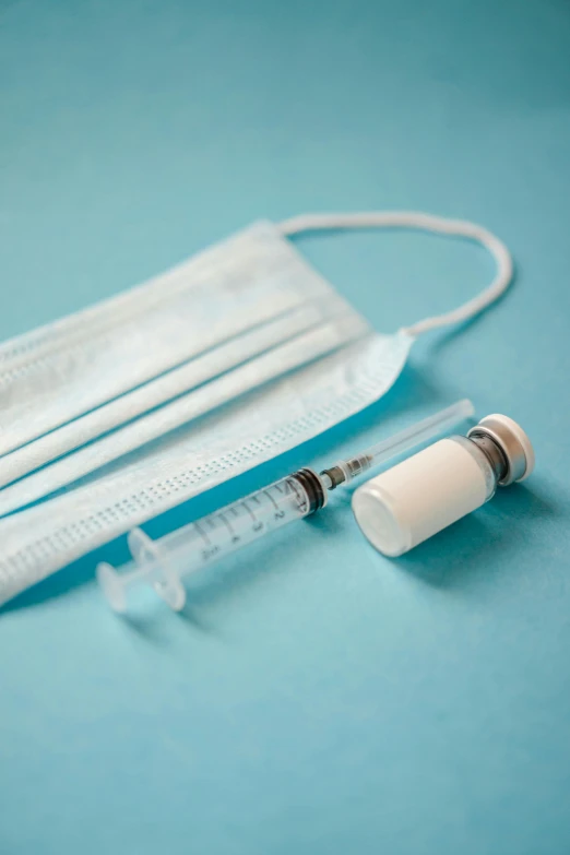 an iv and a tube laying on top of a blue table