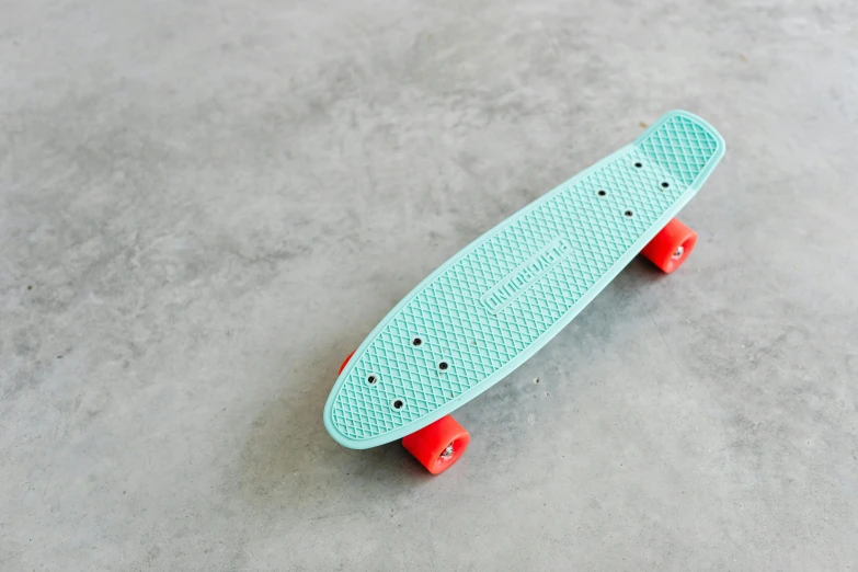 skateboard on cement with white dots in front