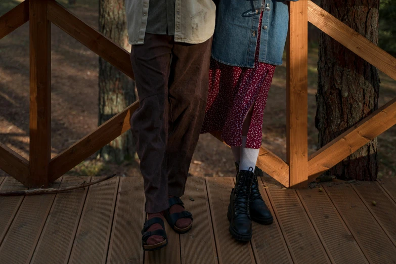 a couple standing next to each other under an umbrella