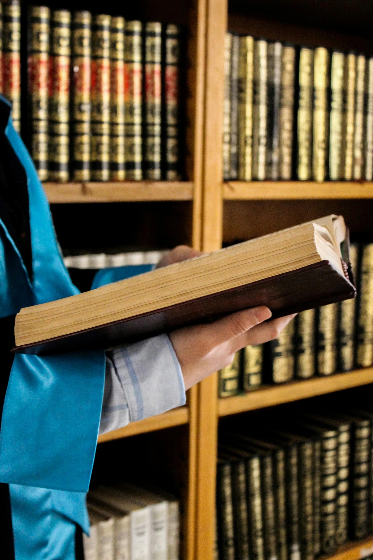 a woman in uniform is holding a book