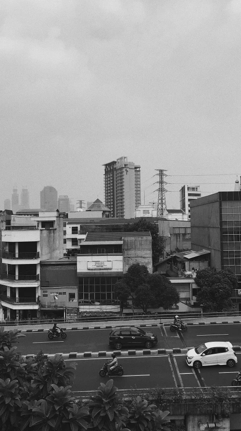 an overcast city and a parking lot in the foreground