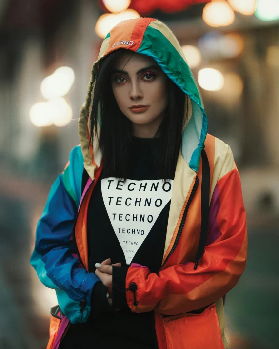 a woman in an orange and blue jacket wearing a hoodie