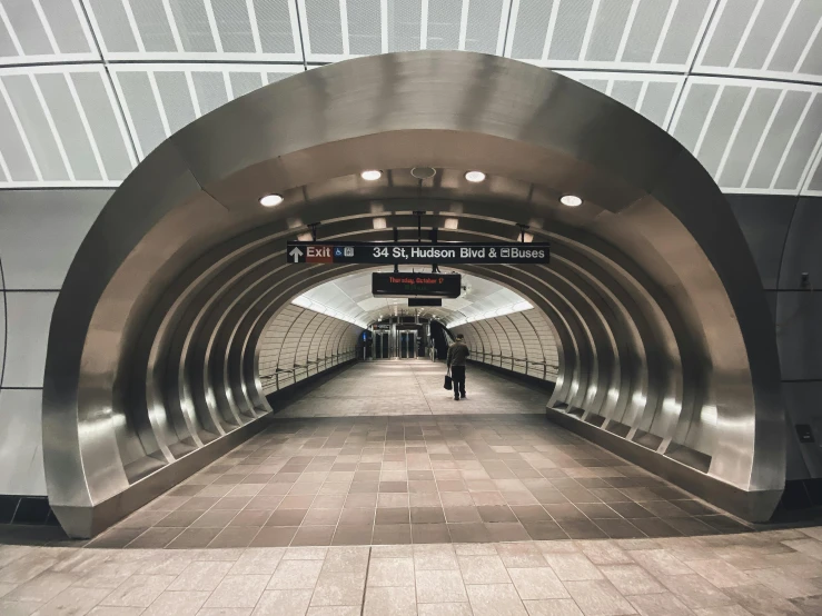 a very large long silver tunnel with people