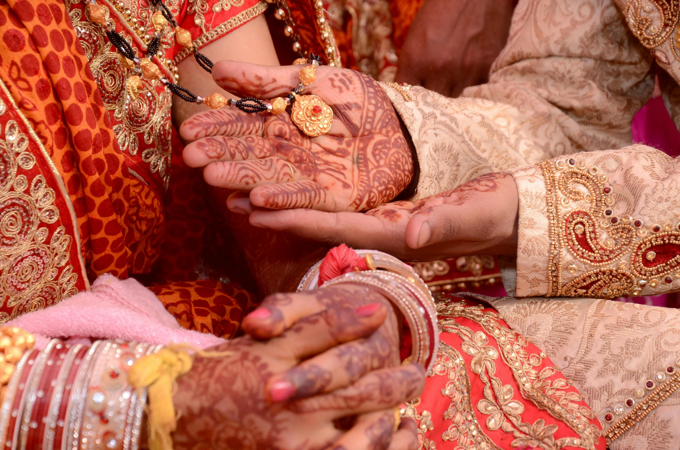 a person and another person putting henna on their hands