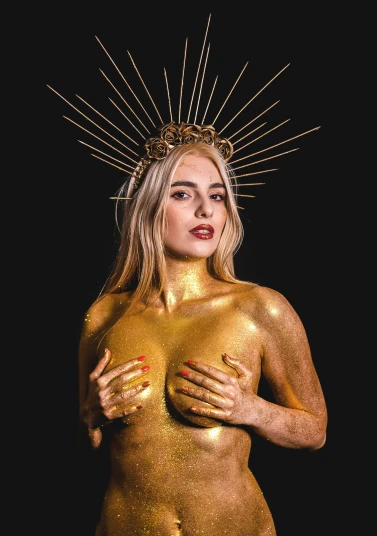 a  lady with gold paint on her body