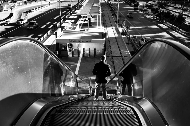 man on escalator of an empty station